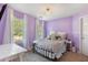 This bedroom features calming lavender-painted walls, carpet, and natural light at 2505 Hamilton Parc Ln, Buford, GA 30519
