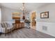 Dining room with wood floors, wainscoting, chandelier and view to kitchen at 2505 Hamilton Parc Ln, Buford, GA 30519