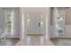 Bright entryway with neutral tile floor and classic paneled front door at 2505 Hamilton Parc Ln, Buford, GA 30519