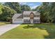 Charming two-story home with blue shutters, well-manicured lawn, and attached two car garage at 2505 Hamilton Parc Ln, Buford, GA 30519