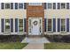 Charming home entrance featuring a white front door with a floral wreath and brick accents at 2505 Hamilton Parc Ln, Buford, GA 30519