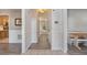 Hallway featuring wood floors, wainscoting, and view to kitchen at 2505 Hamilton Parc Ln, Buford, GA 30519