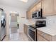 This kitchen features stainless steel appliances, light cabinets, and tile flooring at 2505 Hamilton Parc Ln, Buford, GA 30519