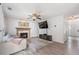 Bright living room boasts a fireplace, hardwood floors, mounted TV, and neutral paint at 2505 Hamilton Parc Ln, Buford, GA 30519