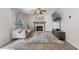 Cozy living room features a fireplace, hardwood floors, mounted TV, and lots of natural light at 2505 Hamilton Parc Ln, Buford, GA 30519