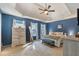 This main bedroom features trey ceilings, neutral carpet, and calming blue accent walls at 2505 Hamilton Parc Ln, Buford, GA 30519