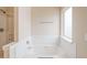 Clean bathroom showcasing a relaxing soaking tub and window, providing natural light at 3019 Iona Ct, Snellville, GA 30039