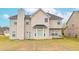 The back exterior of the two-story home boasts ample window lighting and a well-kept lawn at 3019 Iona Ct, Snellville, GA 30039