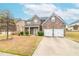 Charming two-story brick home featuring a two-car garage and a welcoming covered front porch at 3019 Iona Ct, Snellville, GA 30039