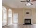 Open-concept living room with fireplace and archways to other rooms at 3019 Iona Ct, Snellville, GA 30039