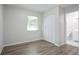 Bright bedroom with hardwood floors, window, closet, and bathroom access at 3436 Adkins Nw Rd, Atlanta, GA 30331