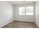 A bedroom featuring neutral walls, wood-look flooring, and natural light from two windows at 3436 Adkins Nw Rd, Atlanta, GA 30331