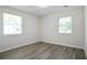 Bright bedroom with wood-look floors and natural light from two windows with privacy blinds at 3436 Adkins Nw Rd, Atlanta, GA 30331
