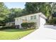 Landscaped front yard leading to a charming one-story home with a new concrete driveway at 3436 Adkins Nw Rd, Atlanta, GA 30331