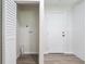 A bright hallway area showcasing a laundry closet and access to an exterior door at 3436 Adkins Nw Rd, Atlanta, GA 30331