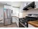 Well-lit kitchen showcases stainless steel appliances, white cabinetry, and wood countertops at 3436 Adkins Nw Rd, Atlanta, GA 30331