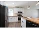 Newly renovated kitchen featuring white cabinets, stainless steel appliances, and butcher block countertop at 3436 Adkins Nw Rd, Atlanta, GA 30331
