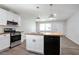 Modern kitchen features white cabinets, stainless steel appliances, wood counters and stylish pendant lighting at 3436 Adkins Nw Rd, Atlanta, GA 30331