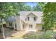 Aerial view of a tan two-story home featuring a small patio, fenced yard and lush green trees at 114 Arborwood Way, Temple, GA 30179