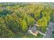 Aerial view of a home with mature trees and a well-manicured lawn in a peaceful neighborhood at 114 Arborwood Way, Temple, GA 30179