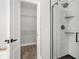 Updated bathroom featuring a stand-up shower with a glass door, and a large walk-in closet at 114 Arborwood Way, Temple, GA 30179