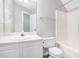 Bright bathroom with white vanity, a large mirror and shower-tub combination with white tile at 114 Arborwood Way, Temple, GA 30179