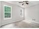 Bright bedroom featuring neutral paint, carpeted floors, a ceiling fan, and natural light at 114 Arborwood Way, Temple, GA 30179