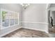 Bright dining area featuring hardwood floors, decorative molding, and ample natural light from a large window at 114 Arborwood Way, Temple, GA 30179