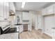 Charming kitchen with white cabinets, granite countertops, stainless steel appliances, and wood-look floors at 114 Arborwood Way, Temple, GA 30179