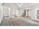 Open-concept living room showcasing a carpeted sitting area and a hardwood-floored dining space at 114 Arborwood Way, Temple, GA 30179