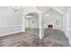 Spacious living area with hardwood floors flowing into carpet, complemented by a cozy fireplace at 114 Arborwood Way, Temple, GA 30179