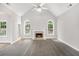 Bright living room featuring vaulted ceilings, a fireplace, and seamless transition to carpet at 114 Arborwood Way, Temple, GA 30179