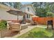 Backyard with patio area featuring seating and a grill, ideal for outdoor enjoyment at 1651 King Rd, Riverdale, GA 30296