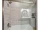 Beautiful bathroom featuring tiled shower with glass door and built-in niche, updated fixtures, and modern lighting at 1651 King Rd, Riverdale, GA 30296