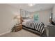 Cozy bedroom featuring stylish decor, soft lighting, and a comfortable bed at 1651 King Rd, Riverdale, GA 30296