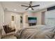 Relaxing primary bedroom boasts a spacious layout, ceiling fan, and a cozy seating area at 1651 King Rd, Riverdale, GA 30296