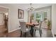 Charming dining area features a wood table, stylish chairs, and a large window offering natural light at 1651 King Rd, Riverdale, GA 30296