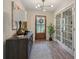 Welcoming entryway with wood floors, decorative light fixture, and stylish decor. French doors to the right at 1651 King Rd, Riverdale, GA 30296