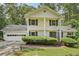 Inviting two-story home featuring a two-car garage, manicured landscaping and a charming front entrance at 1651 King Rd, Riverdale, GA 30296