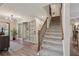 Open hallway with wood floors, stairs leading to the upper level, and easy access to kitchen and living areas at 1651 King Rd, Riverdale, GA 30296