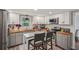 Updated kitchen boasts custom cabinets, butcher block countertops, stainless steel appliances, and breakfast bar seating at 1651 King Rd, Riverdale, GA 30296