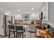 Well-lit kitchen features stainless steel appliances, ample cabinet space, and a convenient island with seating at 1651 King Rd, Riverdale, GA 30296