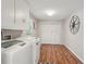 Functional laundry room provides ample space for laundry tasks and storage with cabinets at 1651 King Rd, Riverdale, GA 30296
