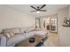 Inviting living area with a large sofa, coffee table, and view of the adjacent room through glass paneled doors at 1651 King Rd, Riverdale, GA 30296