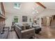 Comfortable living room showcasing a brick fireplace, skylight, hardwood floors, and inviting furniture arrangement at 1651 King Rd, Riverdale, GA 30296