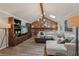 Spacious living room with vaulted ceilings, brick accent wall, modern lighting, and comfortable seating area at 1651 King Rd, Riverdale, GA 30296
