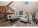 Bright living room featuring a brick fireplace, skylight, hardwood floors, and stylish decor at 1651 King Rd, Riverdale, GA 30296