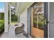 Cozy covered porch with seating area, offering a welcoming entrance with a wooden and glass front door at 1651 King Rd, Riverdale, GA 30296
