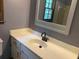 Bathroom featuring a white vanity with a modern faucet and a large, framed mirror at 2751 Herron Cir, Snellville, GA 30039
