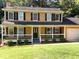 Charming two-story home with a welcoming front porch and a well-manicured lawn at 2751 Herron Cir, Snellville, GA 30039